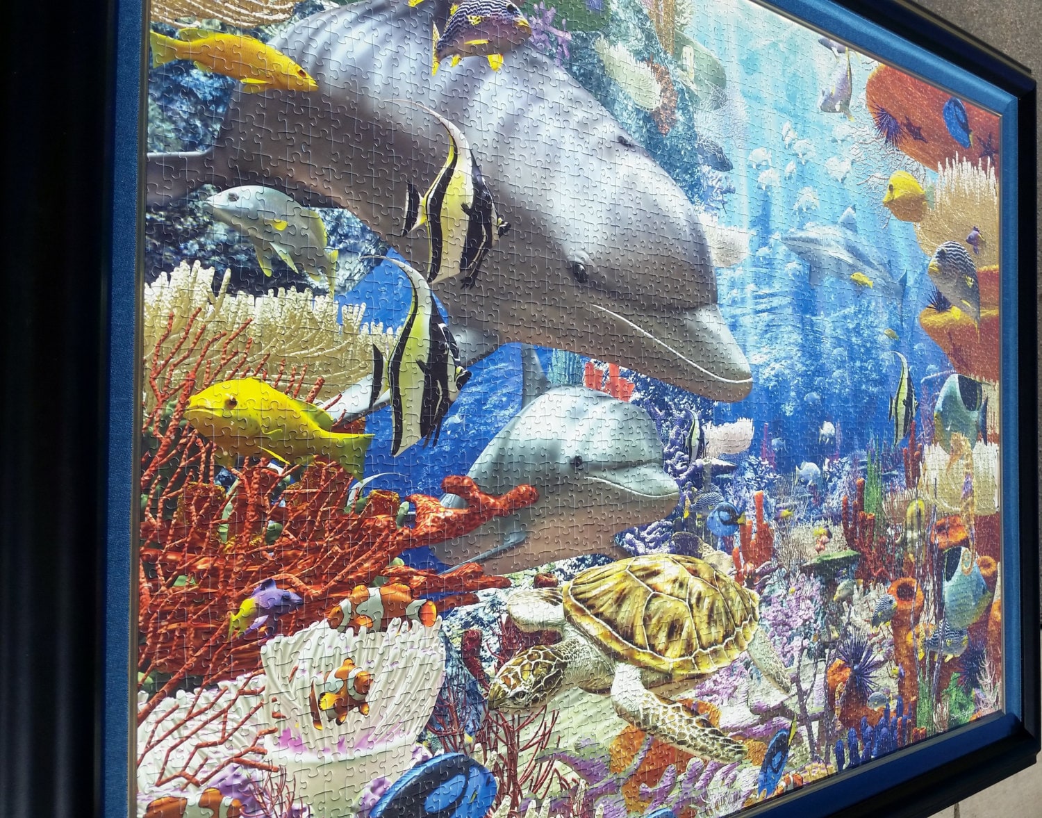 Professionally framed wall art, home decor, and office decor. 3000 piece completed Ocean Ravensburger puzzle framed by Pictures Plus.