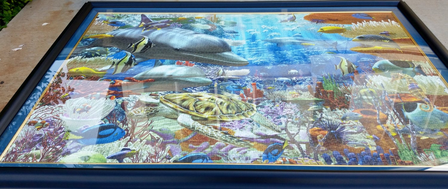 Professionally framed wall art, home decor, and office decor. 3000 piece completed Ocean Ravensburger puzzle framed by Pictures Plus.
